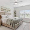 bedroom with lamps and a large window