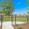 a fenced in yard with a gate and trees