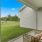 a sun room with chairs and a glass door