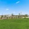 The grounds at River Rocks at Shingle Tree homes for rent in Carolina Shores, NC, featuring a large grassy field.