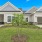 a house with a tree in the front yard